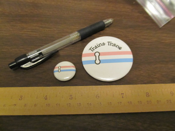1" and 2.5" buttons with the Trains Trans flag